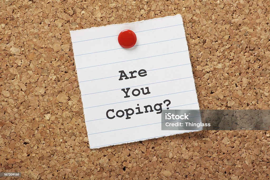 Are You Coping? Are You Coping? on a paper note pinned to a cork notice board. An important question as we deal with increasing workloads and the stress and strain of modern living or illness. Survival Stock Photo