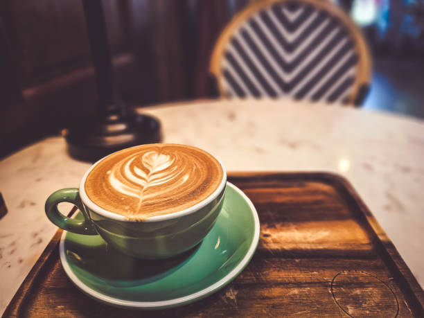 istock Hot cappuccino coffee in a mug Placed on the table in a warm atmosphere. 1872091433