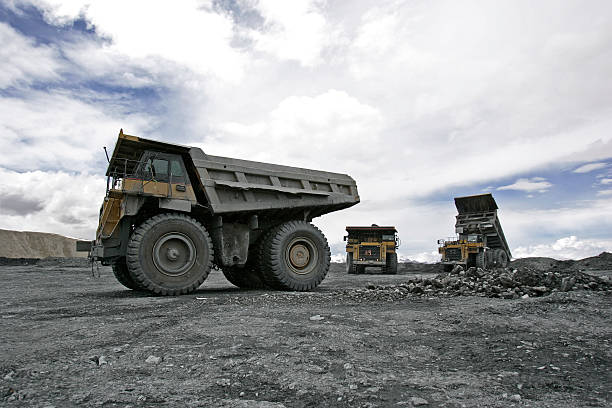 istock Large trucks at mountin gold mine 187212350