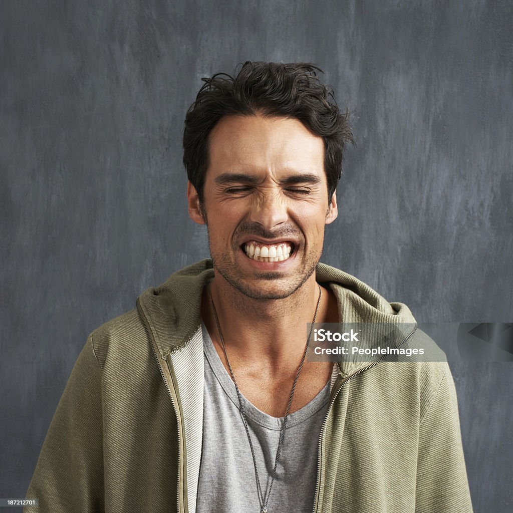 Feeling the frustration A young man grimacing with his eyes closed Clenching Teeth Stock Photo