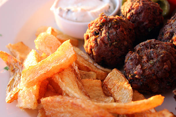 View of a baking tin of Izmir Köfte (Turkish Meatballs)