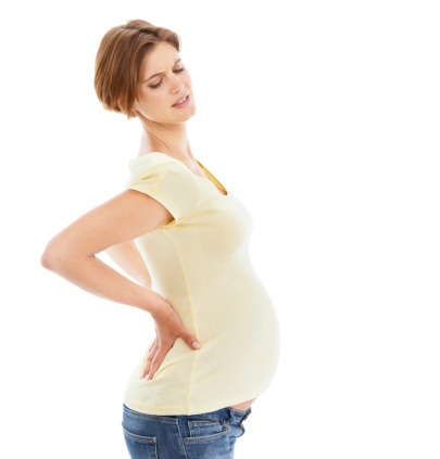 A pregnant woman struggling with back pain while isolated on a white background