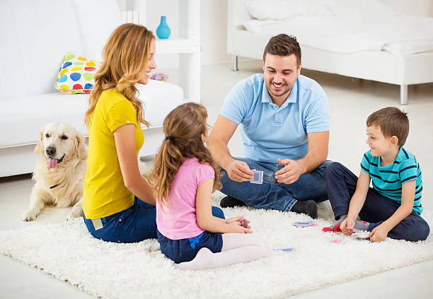 istock Cheerful Family Playing Cards. 187213851