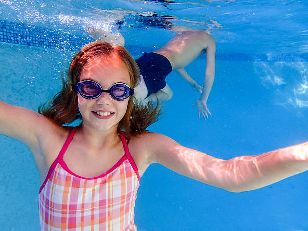 istock young woman swimming underwater in pool 187216502