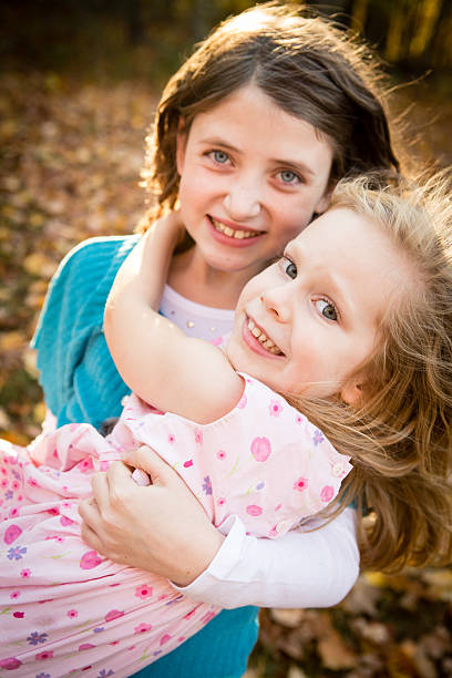 istock Two Cousins/Friends Hugging in Autumn Woods 187216706