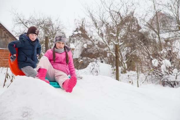 istock Children ride from a snow slide on ice floes. 1872170143