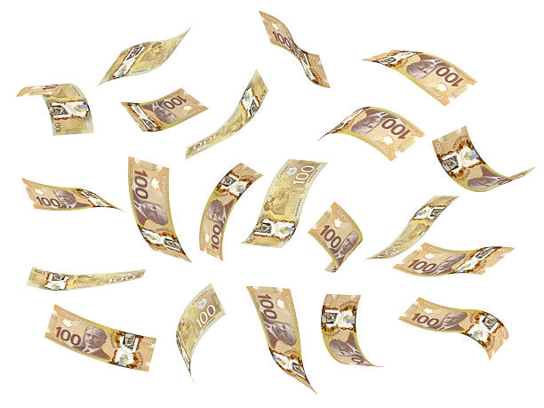 Flying Canadian dollars on a white background stock photo