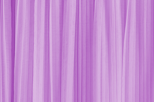 Abstract background of soft pleats of lilac color quilled fabric. Festive background for design. A copy space. Design mockup.