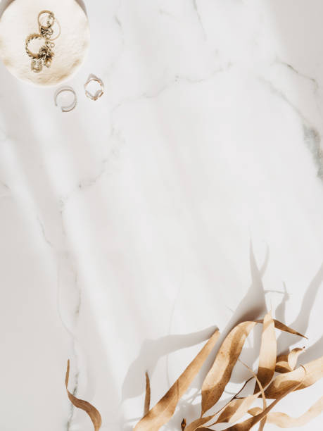 istock Minimal fashion frame with feminine accessories on a white marble dressing table with shadow 1872214585