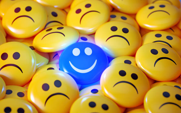 istock Blue Happy Face Emoji Surrounded By Yellow Sad Face Emojis 1872214678