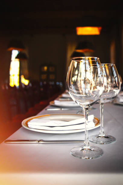 istock Dining table set with wine glasses by the window in a luxury restaurant 1872214747