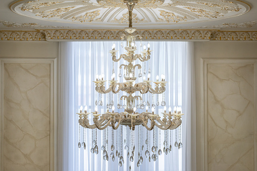 Luxurious expensive chandelier in a royal classic interior.