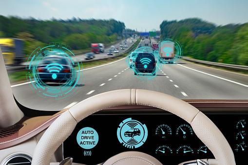 Experience the cutting-edge of automotive innovation with this dynamic image from the driver's perspective of an autonomous vehicle. The dashboard indicates 'AUTO DRIVE ACTIVE' with augmented reality (AR) heads-up display (HUD) elements