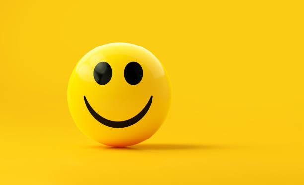 istock Yellow Sphere Textured With Happy Face Emoji On Yellow Background 1872214792