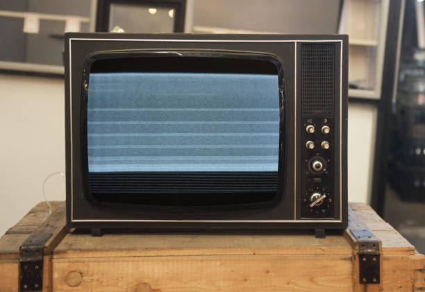 istock An old TV with noise on the screen sits on a box. 1872220198