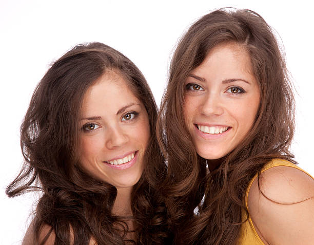 istock Two girls sisters - GEMINI on a white background 187223052
