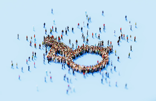 Human crowd forming disability symbol blue background. Horizontal  composition with copy space.