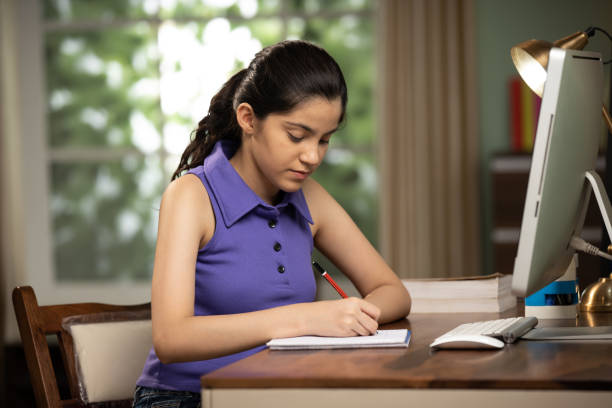 Student girl with computer learning at home