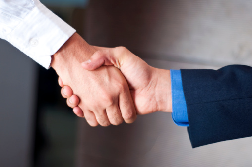 Close-up of hands shake between two businessman