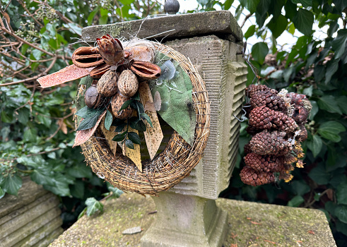 Wreath and pine cones on a tombstone in the public cemetery