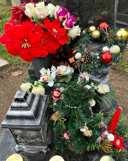 istock Wreath and lantern on a tombstone in the public cemetery 1872258593
