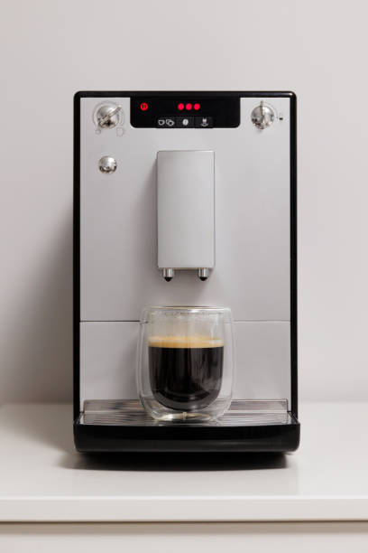 istock modern coffee machine with glass cup of espresso on the table 1872275476