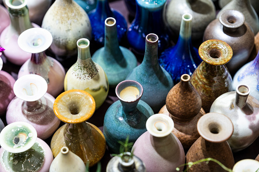 Selection of coloured glass bottles on a rustic background