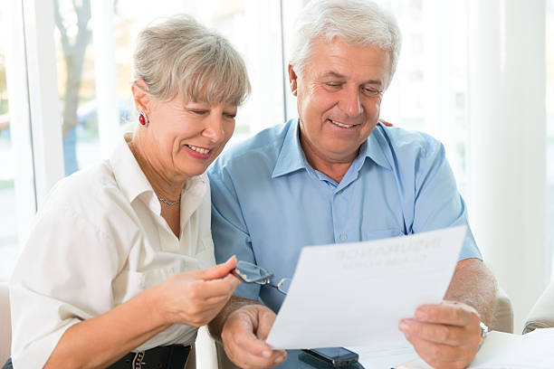istock Senior couple read the form for life insurance 187229631
