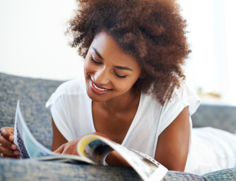 Cute girl engrossed in magazine