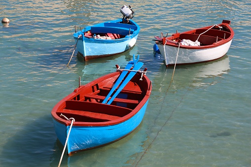 Colorful boats in Giovinazzo fishing harbor in Italy.