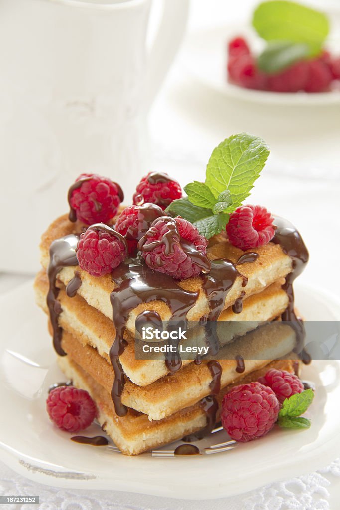 Waffles with raspberry, honey and chocolate. Belgian Waffle Stock Photo