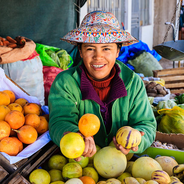 istock Peruvian woman selling fruits, Chivay 187232214