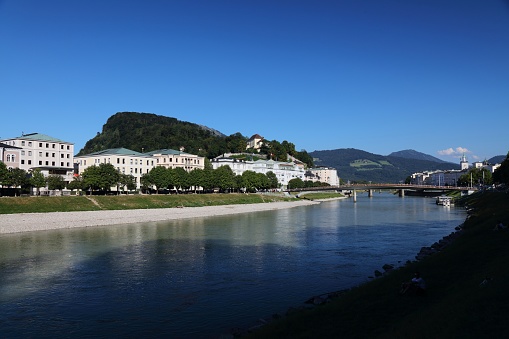 Salzburg, Austria. City view with Elisabethkai riverfront and Kapuzinerberg hill.