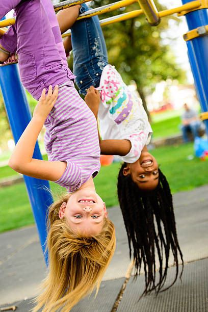 istock Girls hanging on Monkey Bars 187233955