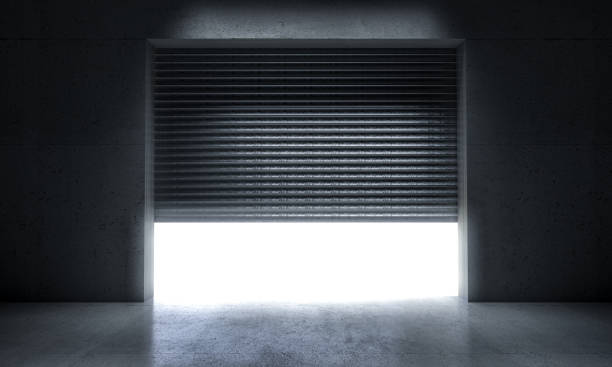 Garage entrance with metal shutter and concrete wall.