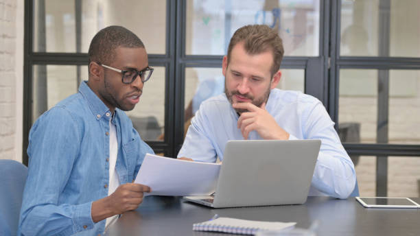 istock African Businessman Discussing Work with Business Partner 1872349338