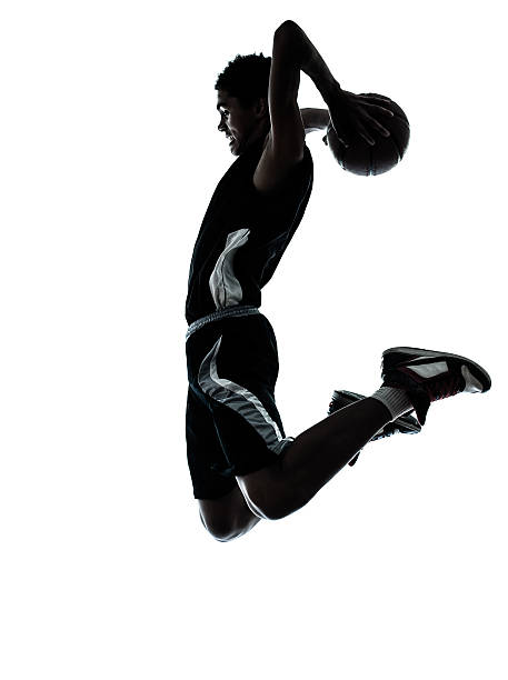 баскетболист дворовой силуэт - слэм данк стоковые фото и изображения