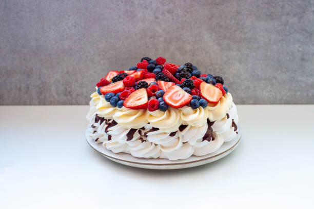 istock Pavlova cake with strawberry, raspberry, blueberry, macarons and chocolate sauce 1872366970