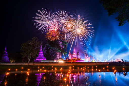 Beautiful Firework scene light color Sukhothai Co Lamplighter Loy Krathong Festival party at The Sukhothai Historical temple park covers the ruins of Sukhothai, in what is now Northern Thailand.
