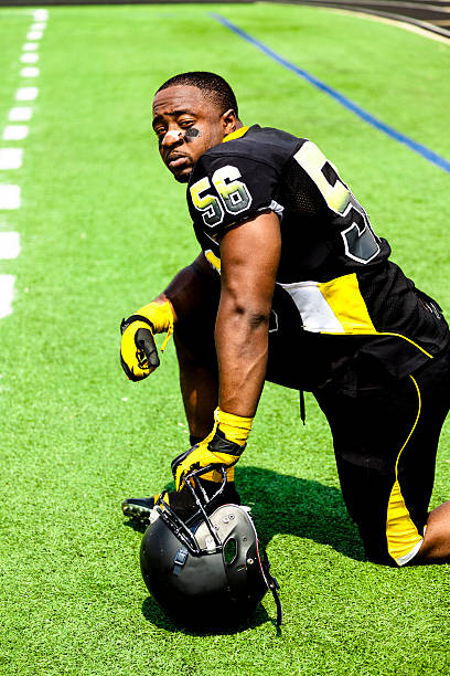 istock Sports: Football player waits on sidelines to reenter game. 187237174