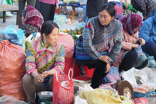 Bac Ha, Vietnam – 10.22.2023: Hmong women selling honey at the morning market in Bac Ha