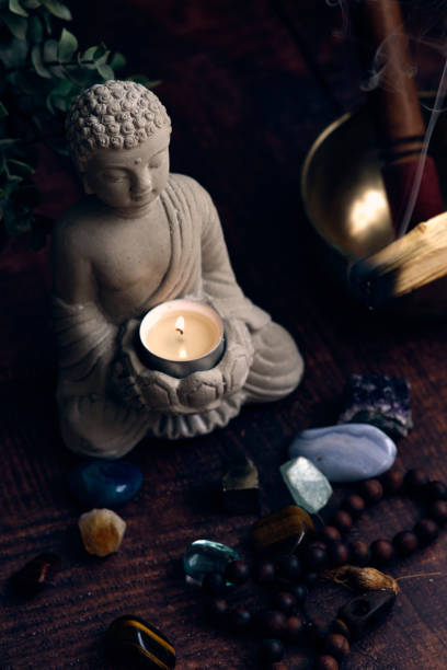 istock stone statue of buddha with a candle 1872381774