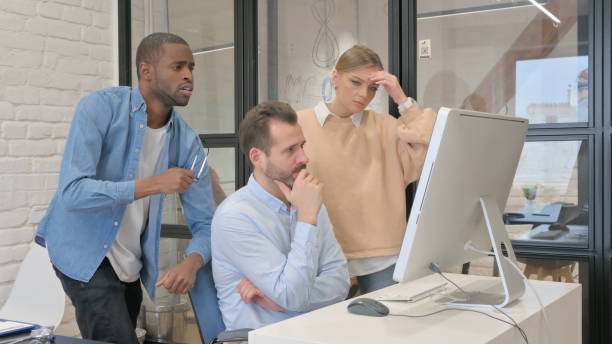 istock Multi Ethnic Young People Reacting to Loss on Computer 1872390706