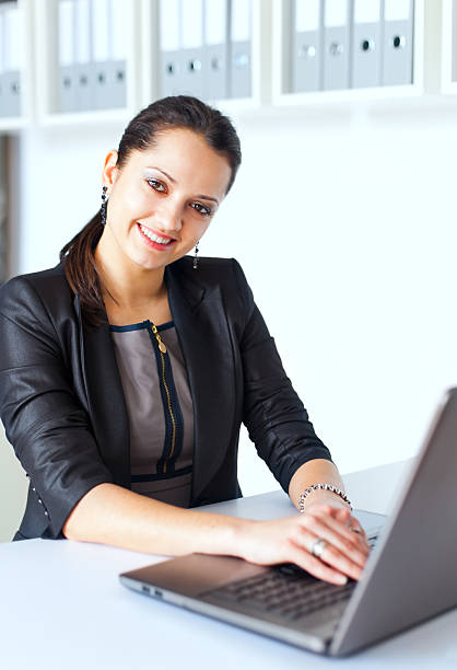 istock Young business woman working on a laptop 187239681