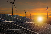 Sustainable Horizon: Solar Panels and Wind Turbines at Dusk