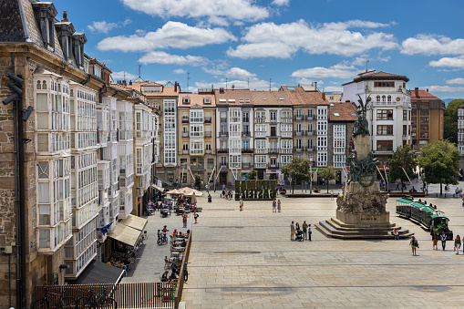 Plaza de la Virgen Blanca, square surrounded by old houses with glass verandas with the monument to La batalla de Vitoria. Vitoria-Gasteiz, Basque Country, Álava, northern Spain.