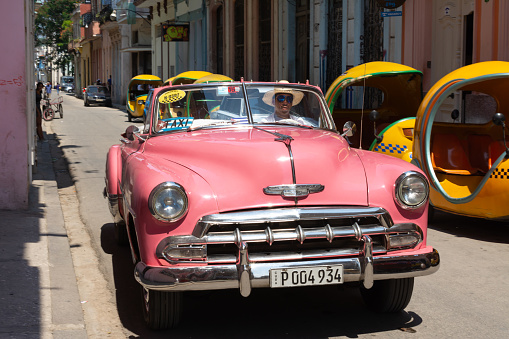 Havana City, Cuba - August 25, 2018: The old pink car is on a city street.