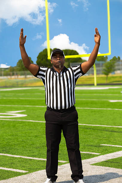 Football referee blowing whistle.   