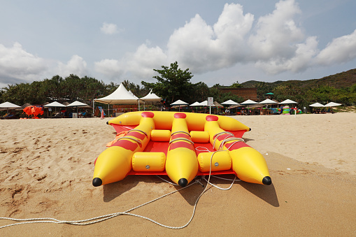 Banana shaped inflatable boat moored on the beach, Sanya City, Hainan Province, China
