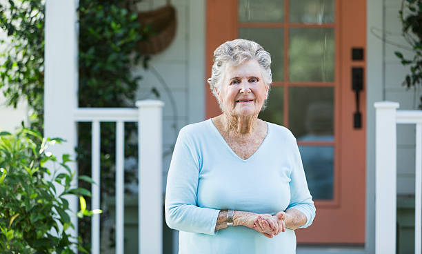 istock Elderly woman outside home 187244375